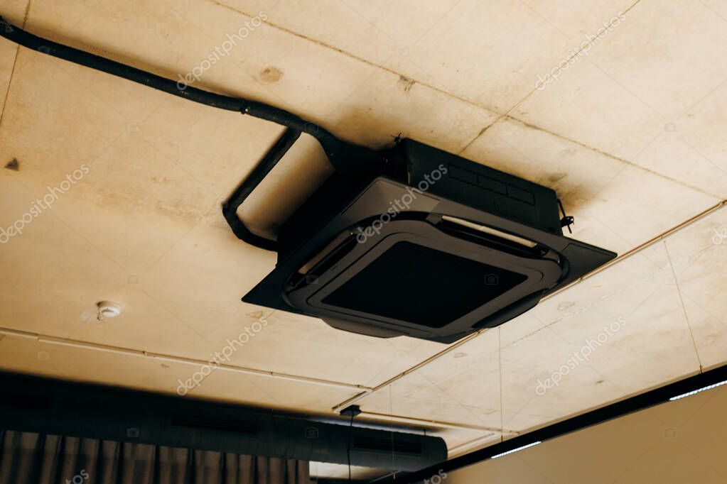 Office ceiling grid with newly installed cassette units.